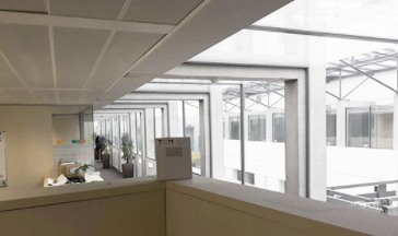 A large office window showcasing a panoramic view of the outside environment, enhancing the workspace's natural light.