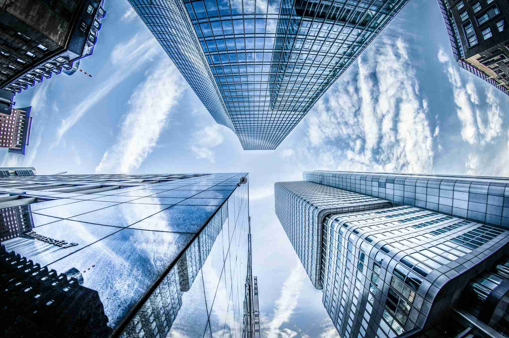 A skyscraper's windows reflect the vibrant colors of the sky, creating a stunning visual harmony between nature and architecture.